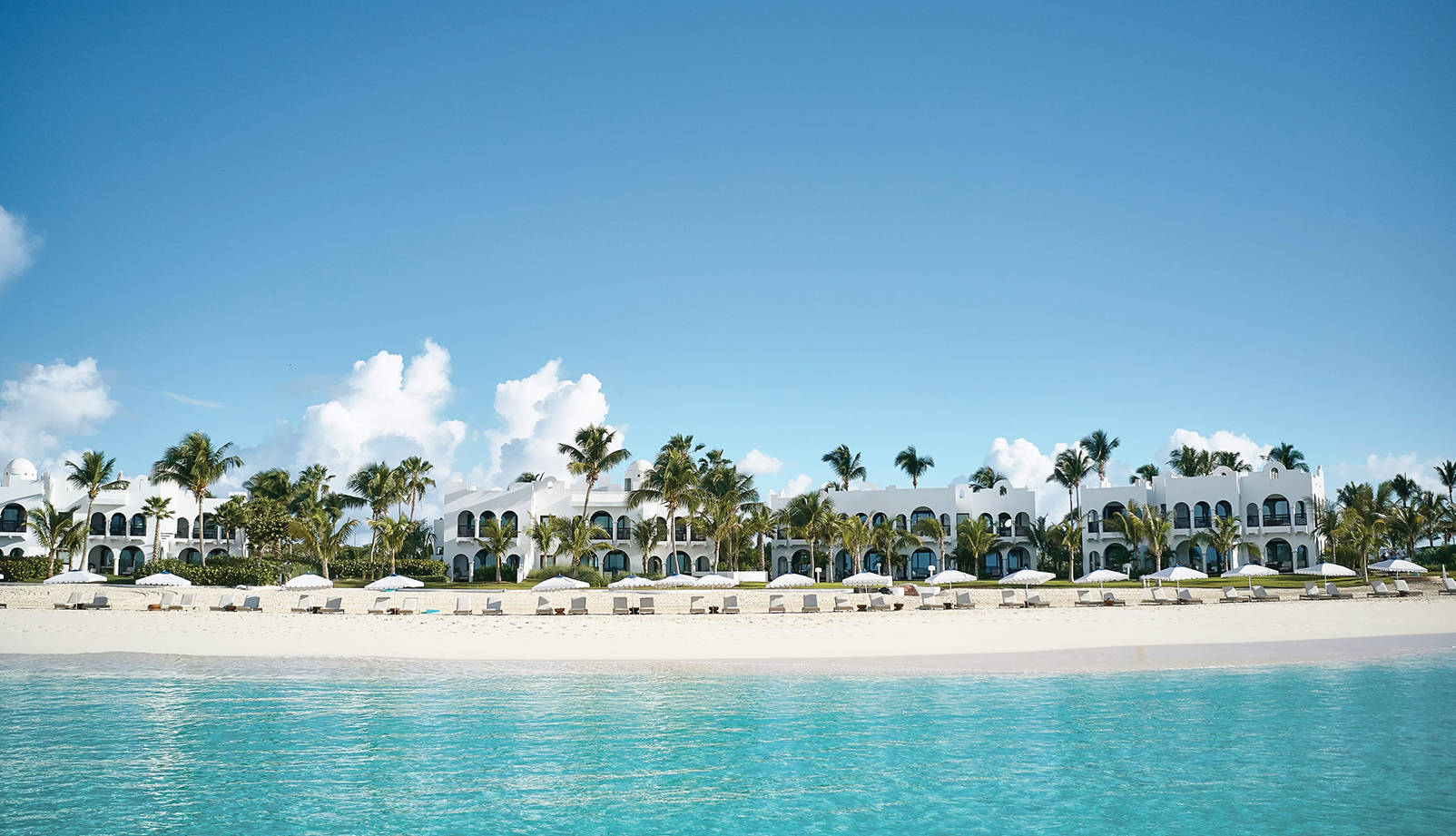 Cap Juluca A Belmond Hotel white sand beach building view from ocean